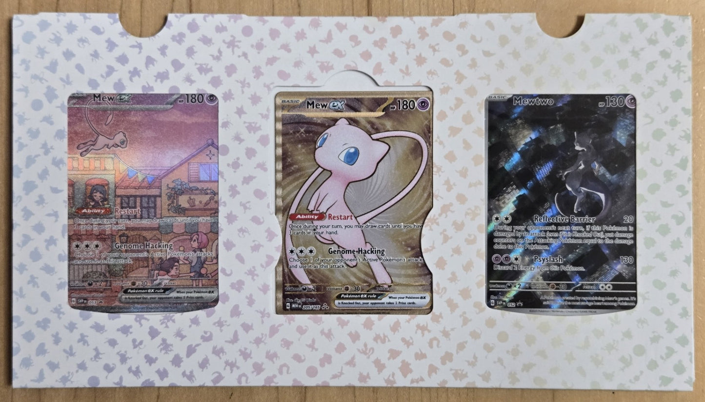 Three trading cards on a patterned card holder with a wooden surface background