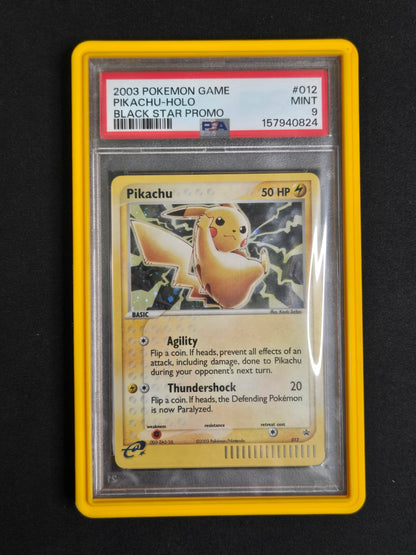 A graded 2003 Pokémon Game Pikachu-holo promo card in a clear PSA slab with a yellow border, photographed against a black background.