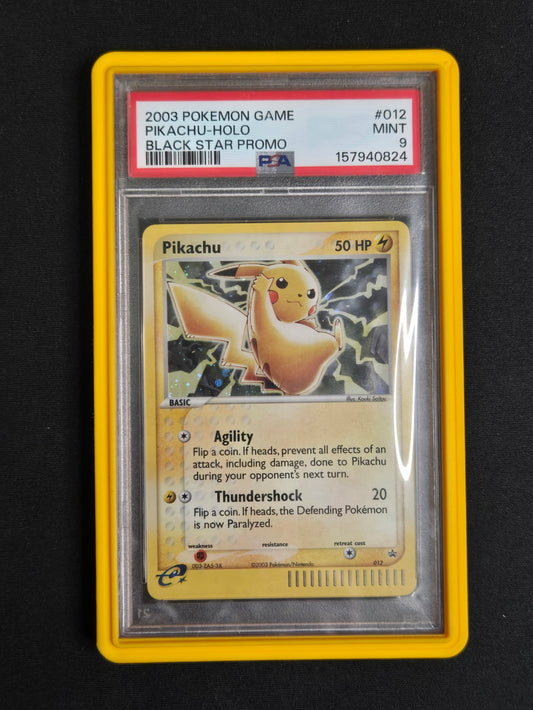 A graded 2003 Pokémon Game Pikachu-holo promo card in a clear PSA slab with a yellow border, photographed against a black background.