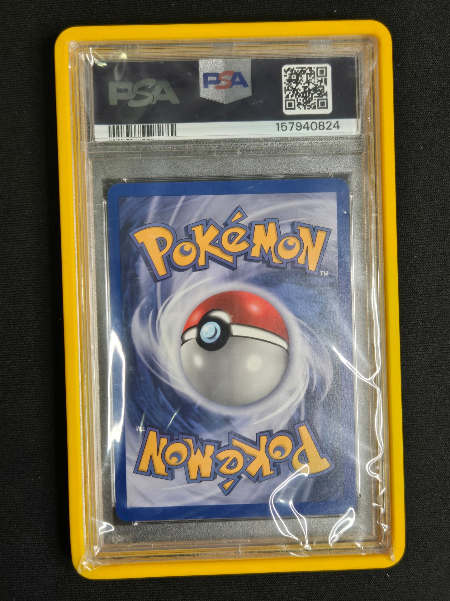 A PSA graded Pokémon trading card in a yellow PSA holder, photographed against a black background. The card features the blue Pokémon logo with a red and silver Poké Ball illustration.