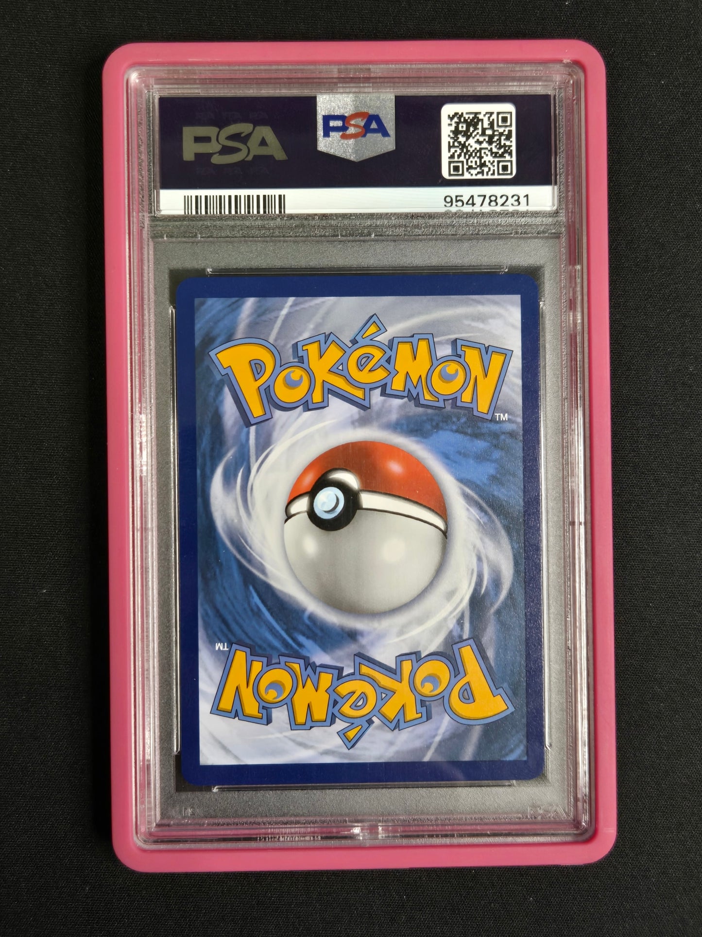 A graded PSA collectible card in a clear plastic slab with a pink border, featuring a Pokémon card with a red and white Pokémon Ball on a blue background.