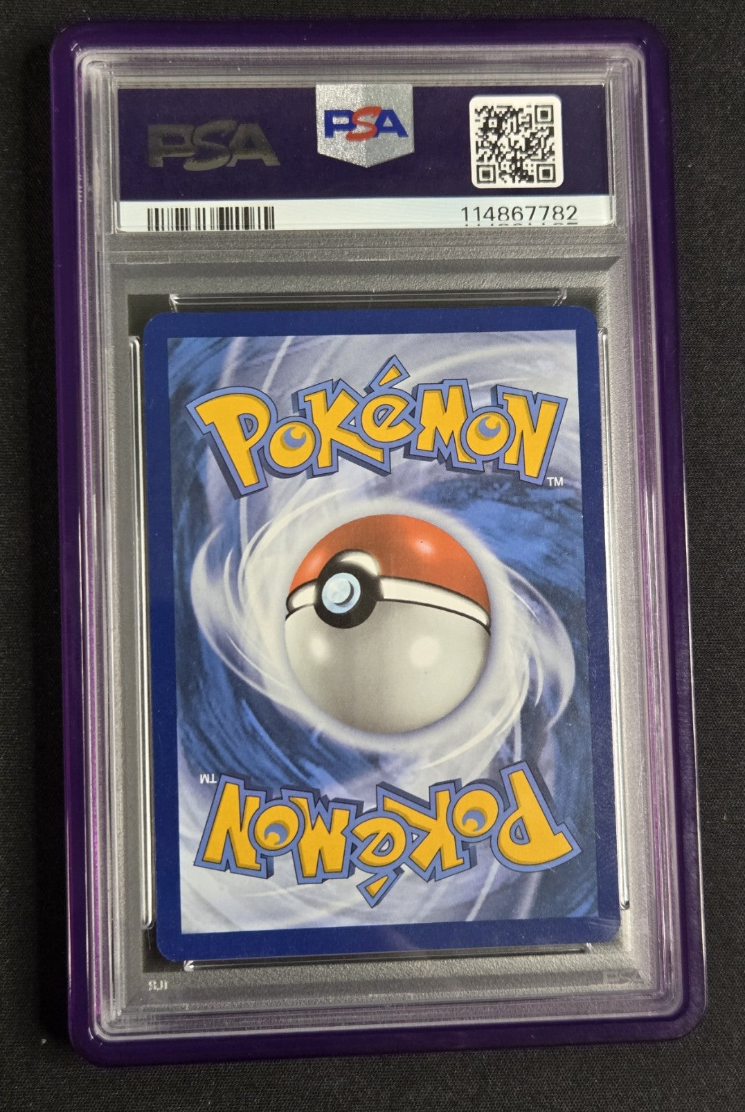 A PSA graded Pokémon card in a purple PSA slab, featuring the blue card back with the yellow Pokémon logo and a red-and-white Pokémon Ball in the center.