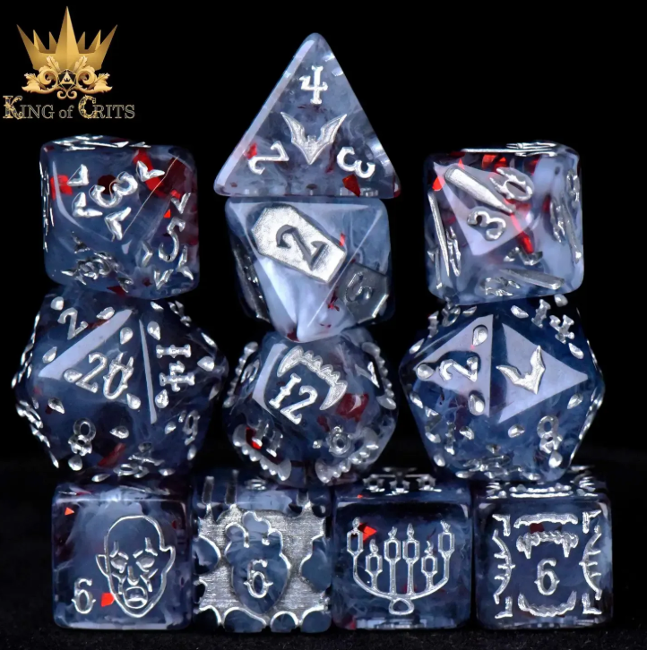 Set of blue and silver polyhedral dice with intricate designs on a black background, featuring the 'King of Crits' logo.