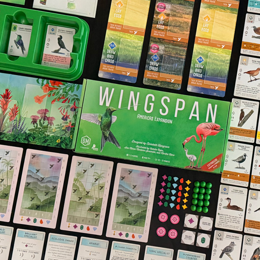 Wingspan board game expansion set with cards and pieces on a black surface